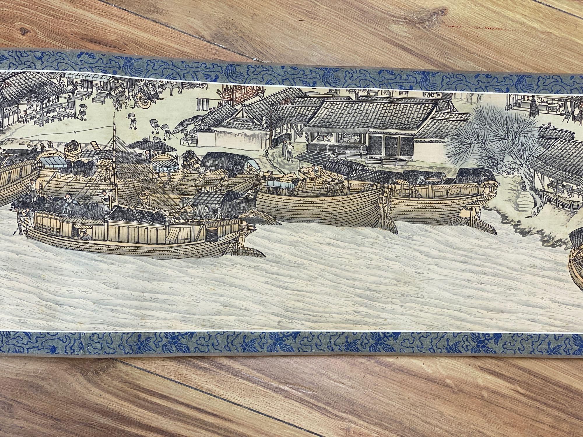 A Chinese landscape painting on silk handscroll with script, approximately 520 x 22cm